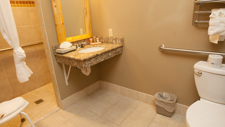 The bathroom in the  accessible Double Queen Suite